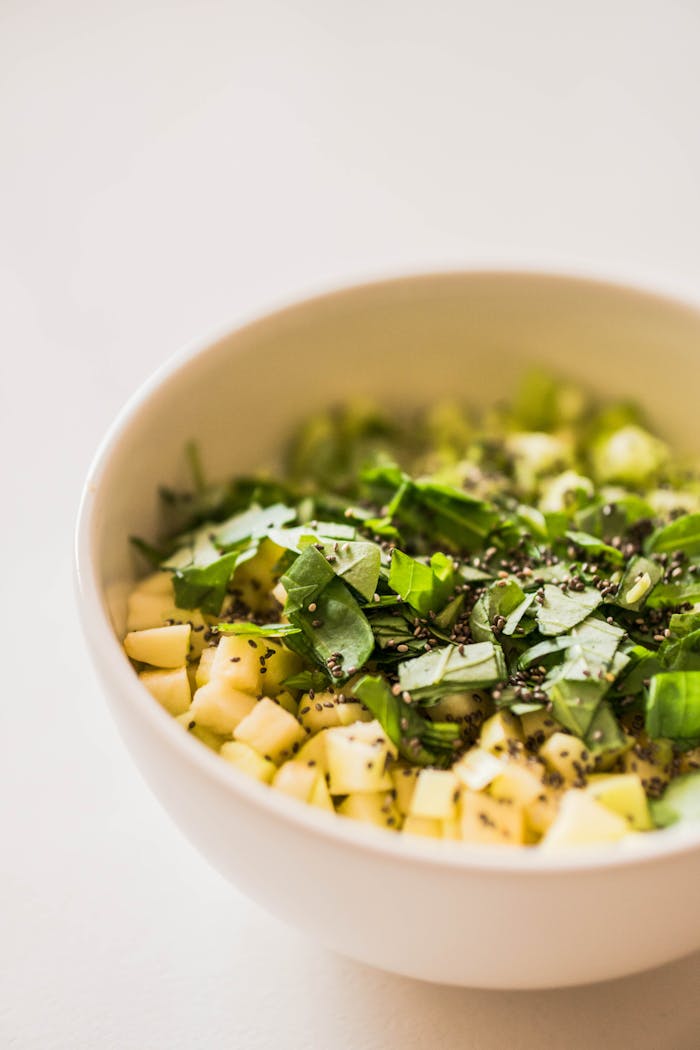 Close-up of diced fruit and herbs creating a vibrant and healthy dish.